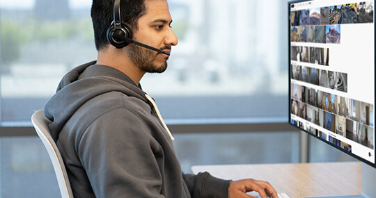 Video surveillance employee watching security cameras